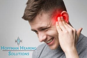 man holding his ear in pain